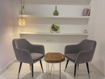 The consulting corner at Ekam, two chairs and a desk, no one in the room.